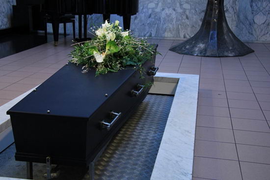 47235423 - funeral flowers on a casket, funeral service